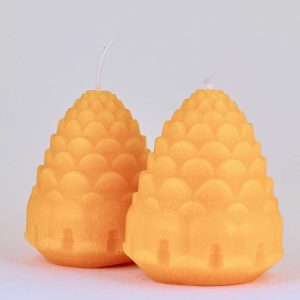 A spruce cone-shaped beeswax candle.